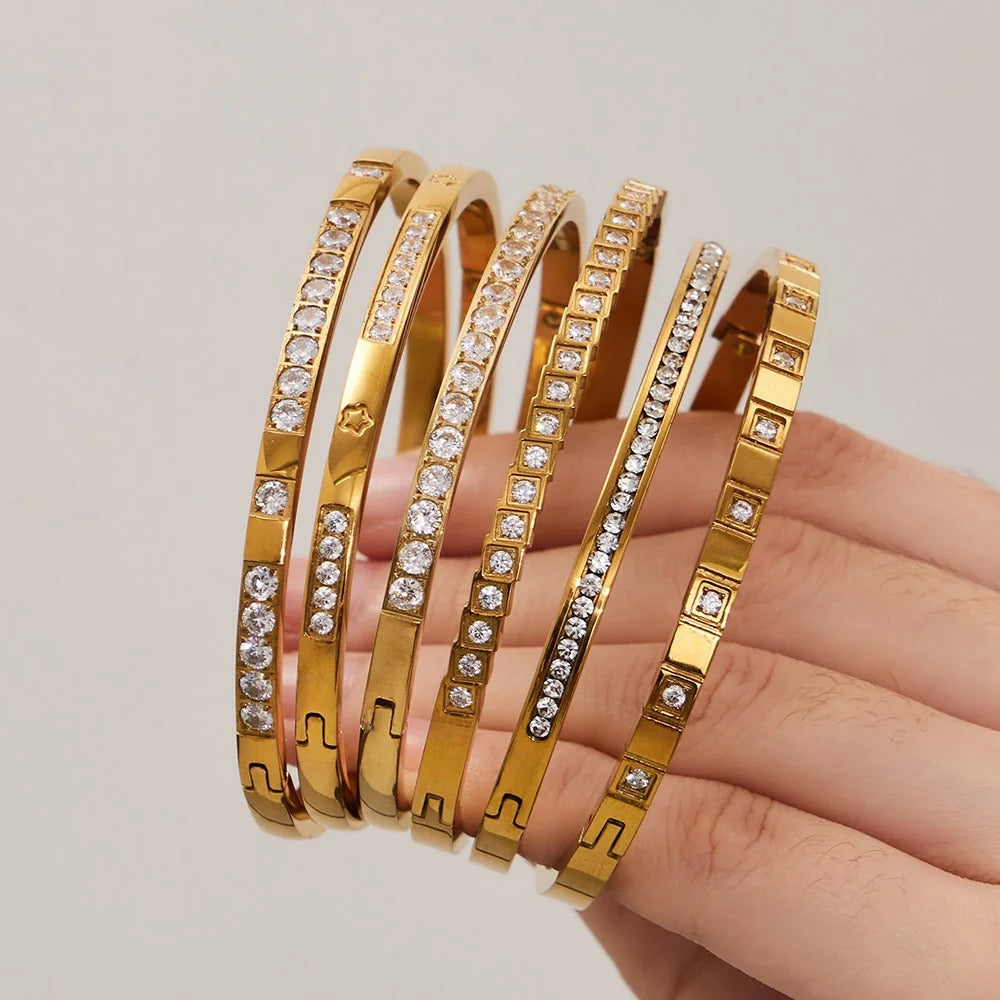 Six Divine bangles held in hand