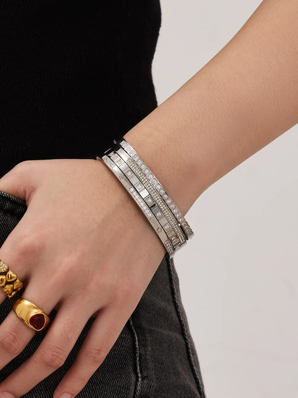 Silver bangles stacked on wrist