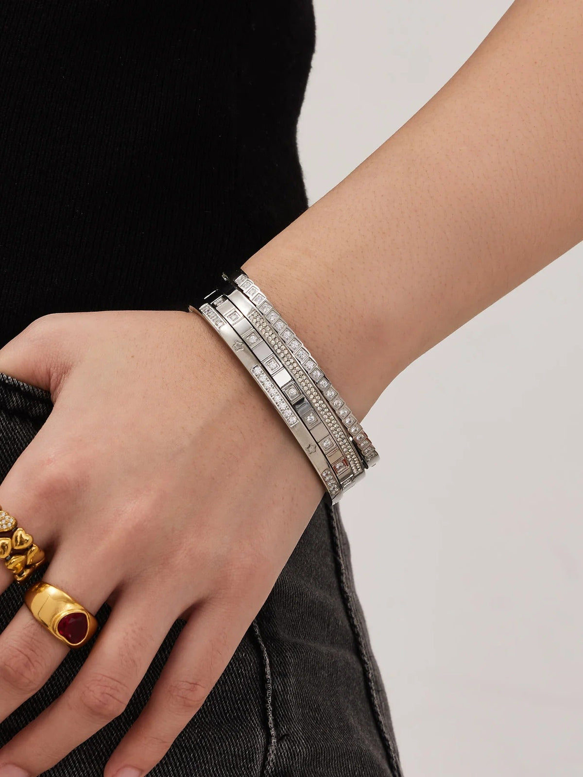 Silver bangles stacked on wrist
