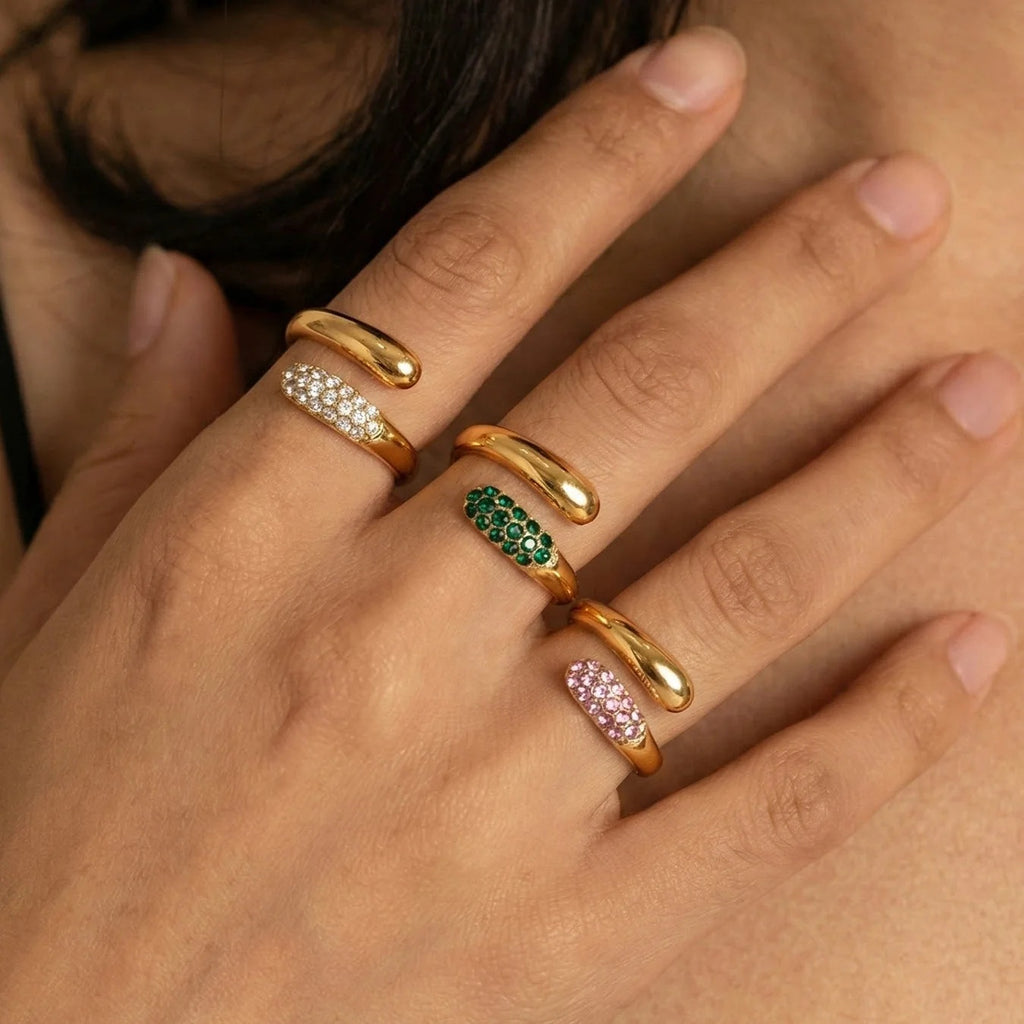 Dewdrop Rings in clear, green and pink stacked on the hand