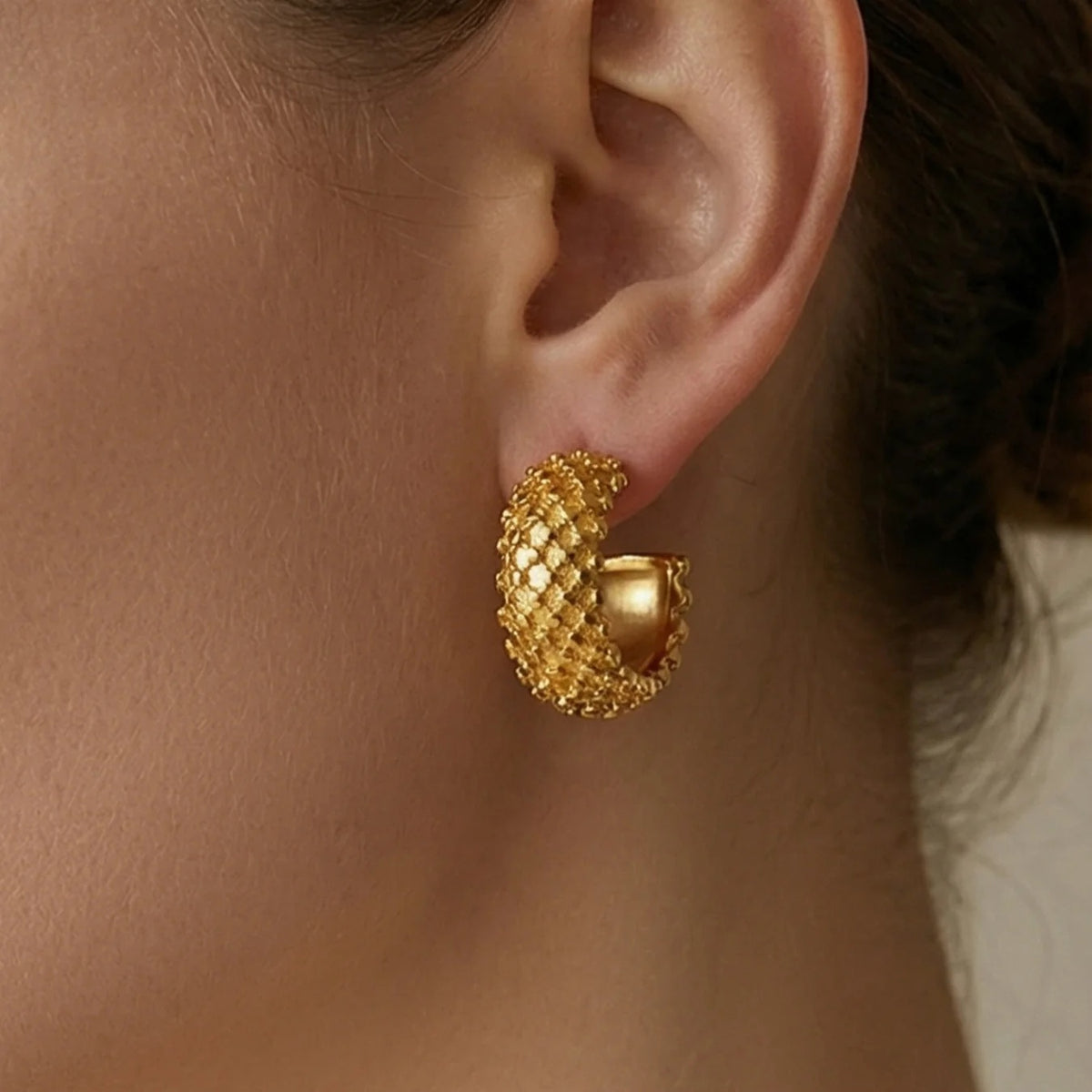 Gold Honeycomb Hoops worn on the ear