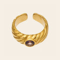 The Lilac Ring, a ribbed gold ring with a purple stone