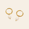 The Pearl Drop Huggies in gold with freshwater pearls
