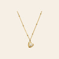 The Sweetheart Necklace, a pearly heart pendant on a gold satellite chain